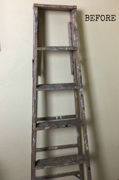 an old wooden ladder leaning against a wall with the words before painted on it in black