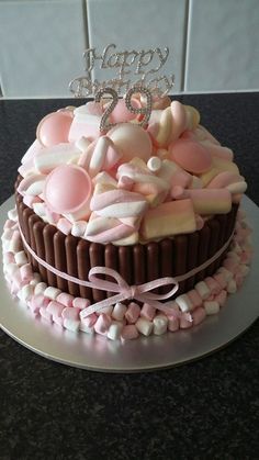 a birthday cake decorated with marshmallows and candies