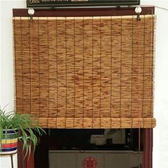 the bamboo blinds are hanging over the fireplace