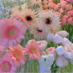 there are many different flowers in the vases on the table, one is pink and white