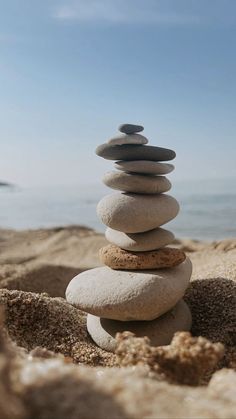 rocks stacked on top of each other in the sand