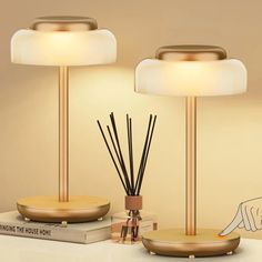 two lamps sitting next to each other on top of a table