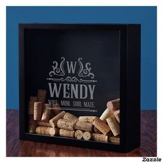 wine corks are arranged in a shadow box