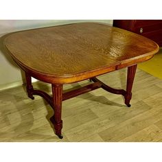 a wooden table sitting on top of a hard wood floor