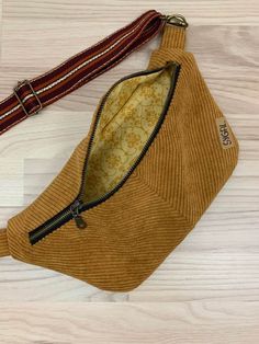 a brown purse sitting on top of a wooden floor