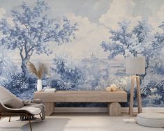 a living room with blue and white wallpaper that has trees painted on the walls