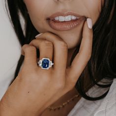 a close up of a person with a ring on their finger and her hand near her face