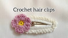 a crochet hair clip with a pink flower on it and the words crochet hair clips written below