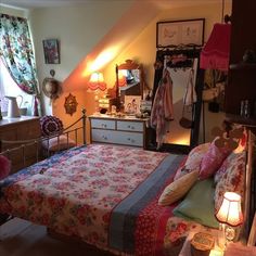 a bedroom with a bed, dresser and window