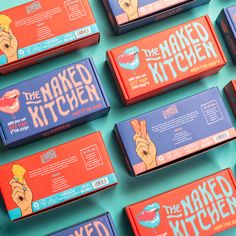 the naked kitchen candy bars are lined up on a blue surface with orange and red boxes