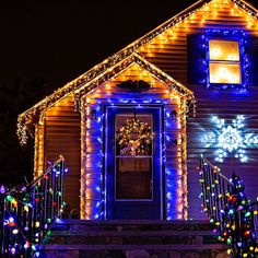 a house decorated with christmas lights and wreaths