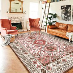 a living room filled with furniture and a red rug on top of a hard wood floor