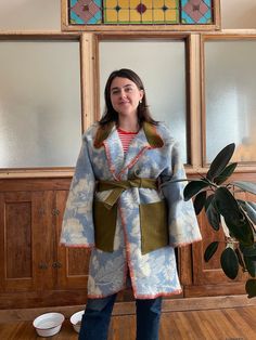 Handmade Vintage Blanket Coat 100% Wool Winter Women's. Handsewn floral blue and off-white. Belted with pockets. Fits S/M/L long wrap style blanket coat made from a vintage blanket, floral pattern. I used an olive green army surplus jacket for the pocket and collar, and did a blanket stitch with wool along the edges. The tie goes internally on the back for a beautiful flow in pattern on the back when tied.  Size small: fits over sized Size medium: fits slightly over sized Size large: fits true to size One of a kind, there's no other one like this! From the brain and heart of Erin Wakeland Vintage Wool Blanket Coat, Diy Blanket Jacket, Blanket Jacket Diy, Blanket Coat Pattern, Army Surplus Jacket, Wool Blanket Coat, Long Quilted Coat, Vintage Wool Blanket, Blanket Jacket