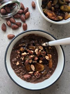 two bowls filled with chocolate pudding and nuts