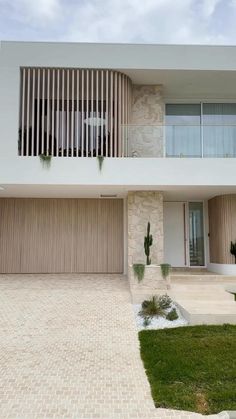 a modern house with an attached balcony and garage