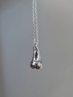 "A beautifully polished Argentium 940 solid silver tooth pendant, individually handmade by me at Ossia Obscure. It was sculpted and designed to scale of a real lower(jaw) human molar.  It hangs on a 24\" Sterling Silver 925 anchor chain and would look really striking on its own or to layer with other pieces of jewellery.  I aimed to combine a high quality piece of fine jewelry with a dark macabre/occult twist. I have a love for creating weird anatomical jewelry and teeth in particular are a favourite of mine. All designs are individually handmade by me in Argentium 940 Silver, a superior option to traditional Sterling 925 containing a higher percentage of silver. It has a brighter or whiter colour and has much greater tarnish and scratch resistance. It has been hallmarked in Dublin's Assay Anatomical Jewelry, Silver Tooth, Tooth Pendant, Alternative Jewelry, Tooth Necklace, Anchor Chain, Argentium Silver, Necklace Unique, Black Jewelry