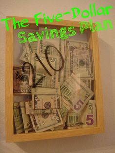 the five dollar savings plan is displayed in a wooden frame with scissors and money bills