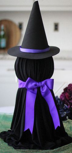 a black and purple witch hat on top of a table