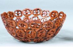 an intricately designed bowl sits on a white surface