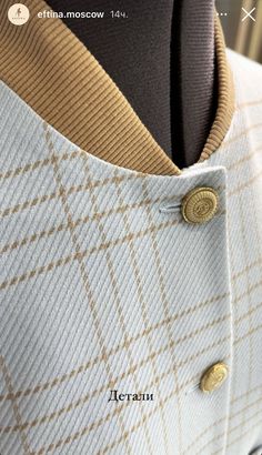 a close up of a jacket with buttons on the lapel and an inscription underneath it