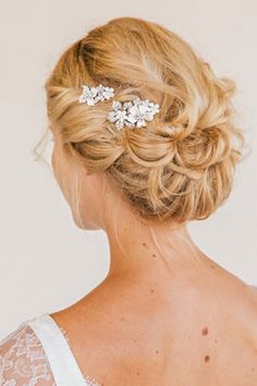 a woman with blonde hair wearing a bridal comb