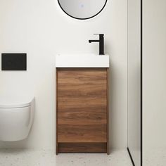 a bathroom with a toilet, sink and mirror