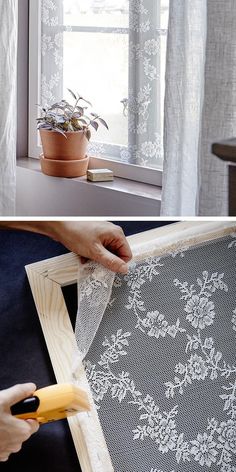 a person is cutting fabric with scissors on a window sill next to a potted plant