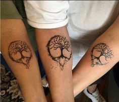 two people with tattoos on their arms and legs, one has a tree in the shape of a heart