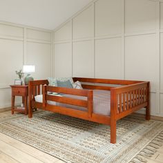 a wooden bed frame sitting on top of a rug