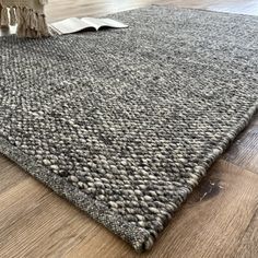 an area rug with a book on top of it