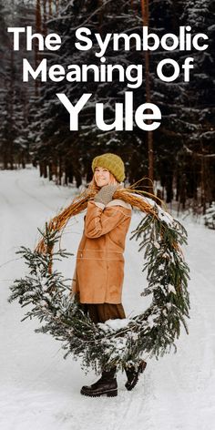 a person holding a wreath in the snow with text that reads, the symbolic meaning of yule