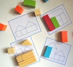 four different shapes and sizes of wooden blocks on a white surface with colored pencils