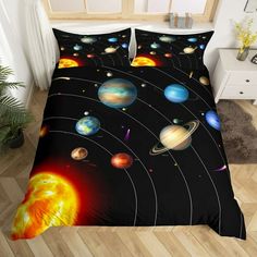 the solar system is depicted on this black bedding set with white pillows and pillow cases