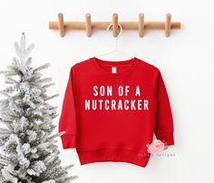 "Son Of  Nutcracker Kids Sweatshirt, Boys Christmas Sweatshirt, Toddler Sweatshirt, Kids Christmas Sweater, Youth Sweatshirt, Christmas Shirt Funny Christmas sweatshirt - perfect for upcoming sweater weather ♥ 📋 HOW TO ORDER: 1. Select the size 2. Select the color if required  3. Select the quantity 3. Add personalization if required 4. Add to Cart (\"buy now\" will take you directly to checkout and \"add to cart\" will allow you to continue shopping with us) 5. Submit order (Shipping will auto Toddler Christmas Sweatshirt, Toddler Christmas Shirts Boy, Funny Kids Christmas Shirts, Kids Christmas Shirts Vinyl, Boys Christmas Shirts, Toddler Christmas Sweater, Kids Christmas Sweater, Kids Christmas Shirts, Christmas Shirts Vinyl