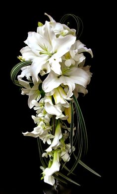 a bouquet of white flowers sitting on top of a table