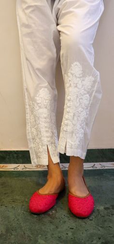 Relaxed Fit Cotton Pants with opening and button inserts. Embroidered in chikankari by skilled artisans. Length - 38/39 inches Size -  S -  waist stretched fits upto 40 M - waist stretched fits upto 42 L -  waist stretched fits upto 44 XL - waist stretched fits upto 46 XXL - waist stretched fits upto 48/50 Cotton Sets With Embroidered Border, Traditional Embroidered Ankle-length Bottoms, Traditional Unstitched Pants With Embroidered Border, White Floral Embroidery Pants For Festive Season, Festive White Pants With Floral Embroidery, White Chikankari Embroidery Sets With Straight Pants, Elegant Straight Pants With Embroidered Border, Fitted White Embroidered Bottoms, Festive Straight Pants With Floral Embroidery