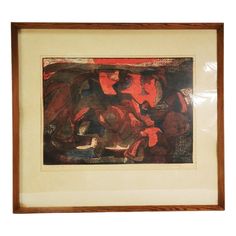 an abstract painting with red and black colors in a wooden frame on a white wall