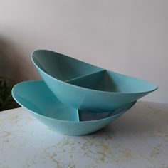 three blue bowls sitting on top of a table