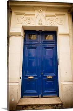 two blue doors in front of an old building