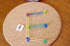 a cork board with pins and letters on it