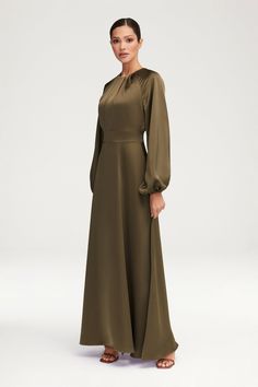 Indulge in luxury with our Luna Satin Balloon Sleeve Maxi Dress in Olive. The elegant pleated neckline and banded waist create a timeless silhouette, while the balloon sleeves add a touch of drama. Perfect for any special occasion, this dress exudes sophistication and exclusivity. Model is 5'7" and is wearing size XS/58". Olive Colored Dress, Women Nightwear Dresses, Long Sleeve Satin Dress, Night Wear Dress, Moslem Fashion, White Dress Formal, Nikkah Dress, Eid Outfit, Pleated Neckline