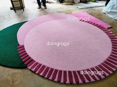 three round rugs with different colors and sizes on the floor next to each other