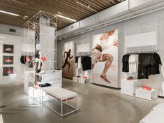 the inside of a clothing store with clothes on display