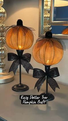 two lamps with bows on them sitting on a table