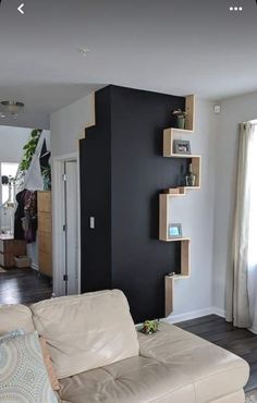 a living room filled with furniture and black walls