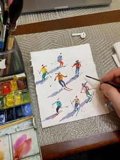 a person is painting with watercolors on paper