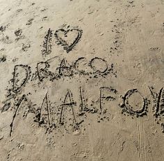 i love drago and malfoom written in the sand