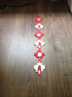 a wooden floor with red and white paper stars on it, arranged in the shape of letters