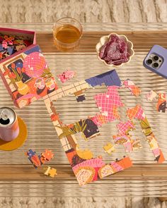 a wooden table topped with assorted items and a cup of tea on top of it