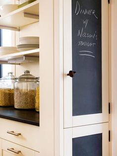 a chalkboard in the corner of a kitchen